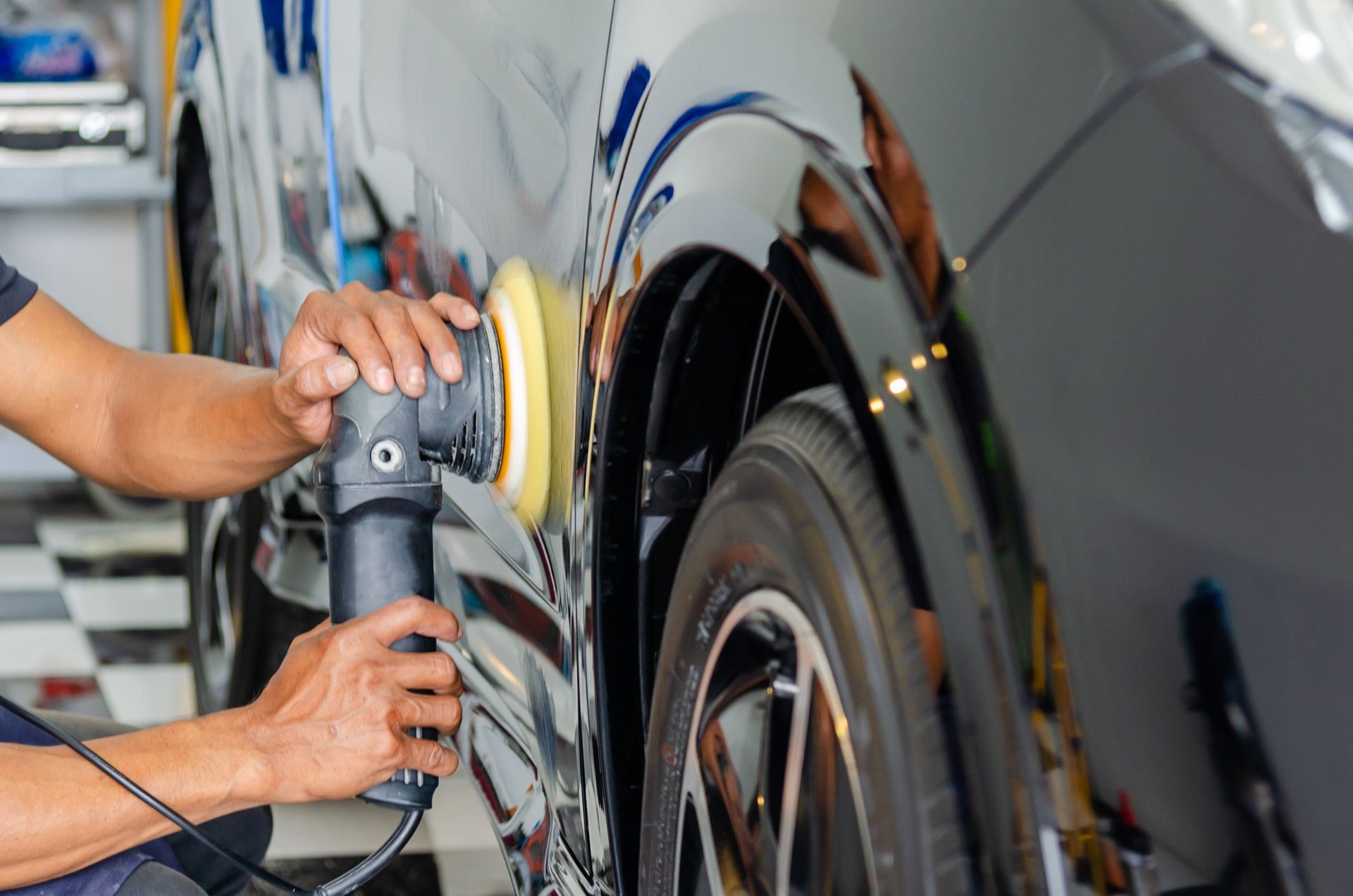 Man hands holding the work tool polish the car.Buffing and polishing car. Car detailing.